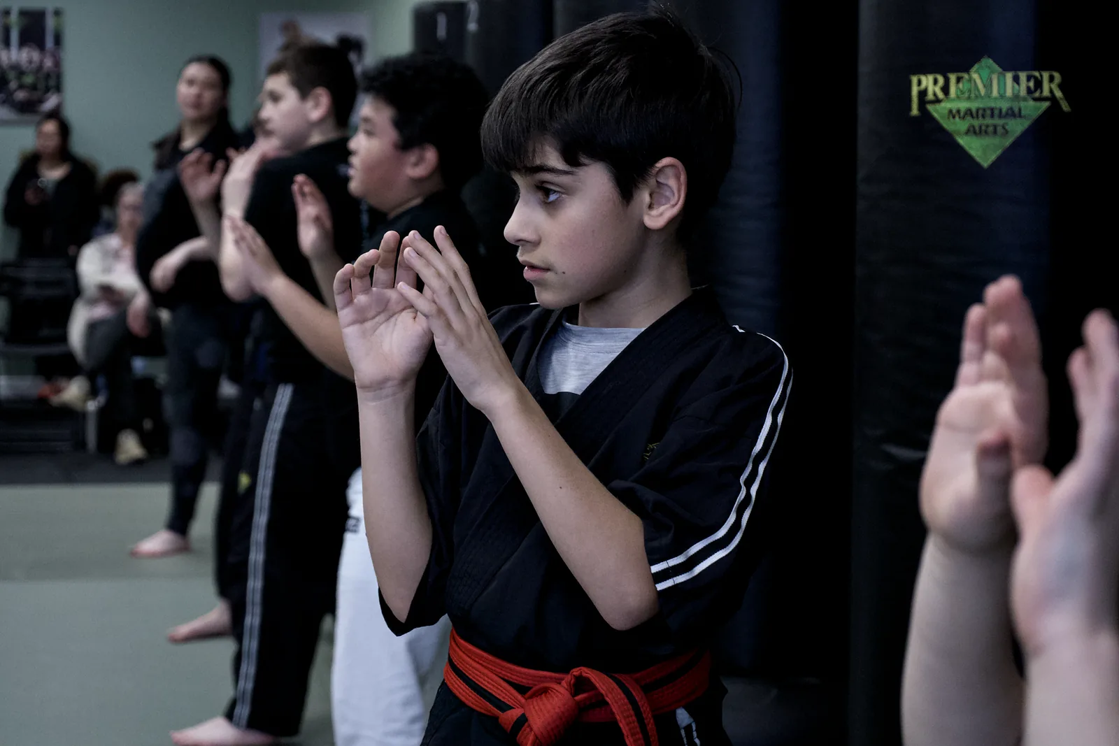 Two boys facing off in a controlled guard, hands up