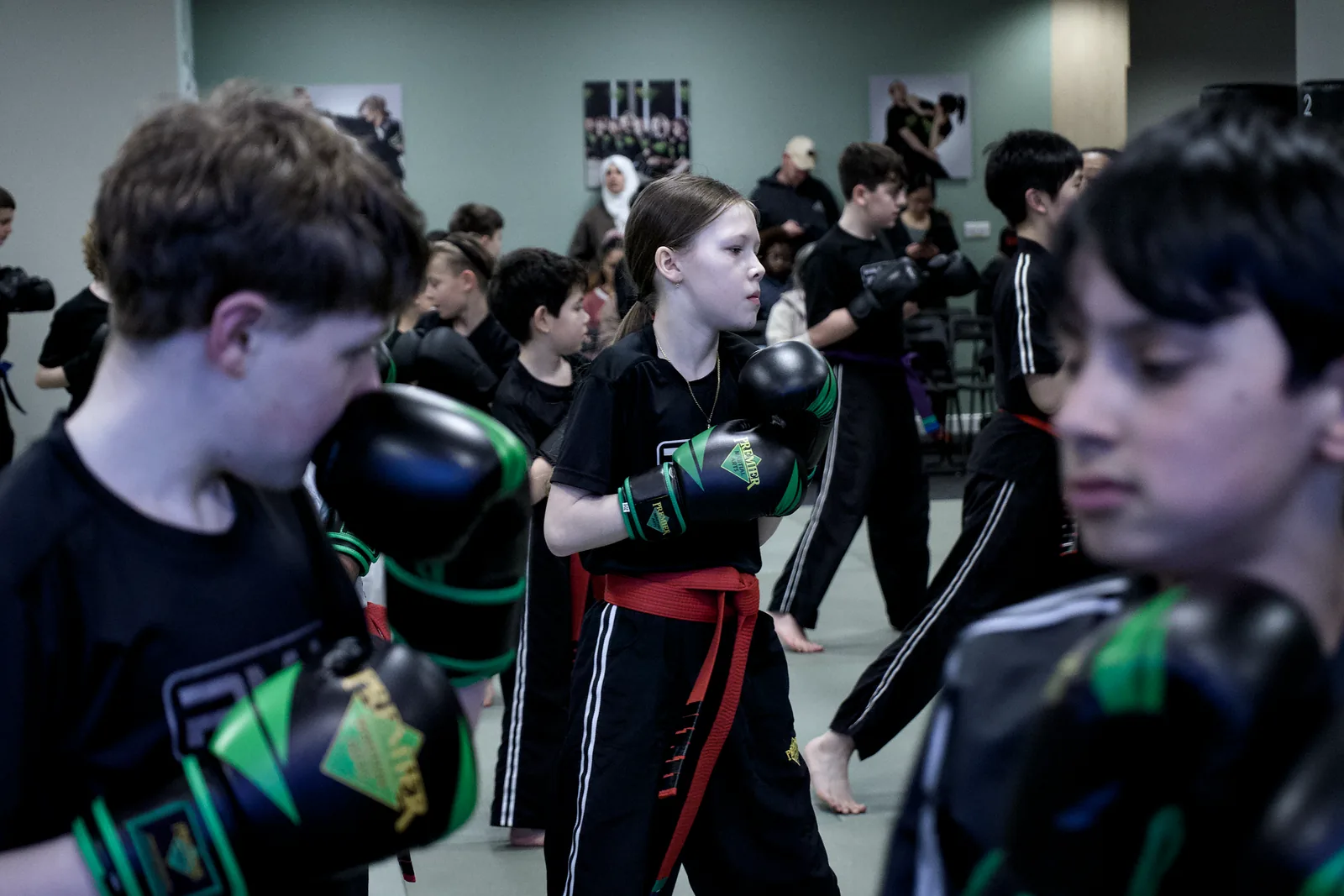 Two children in gloves working a partner drill, close in