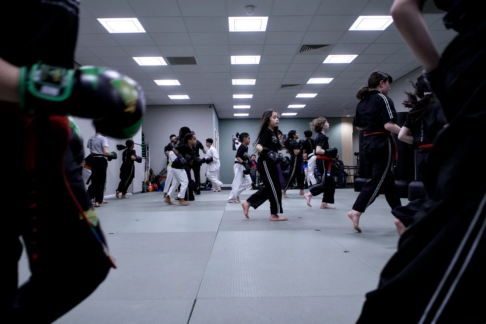 A wide view of a busy class, pairs drilling across the whole mat