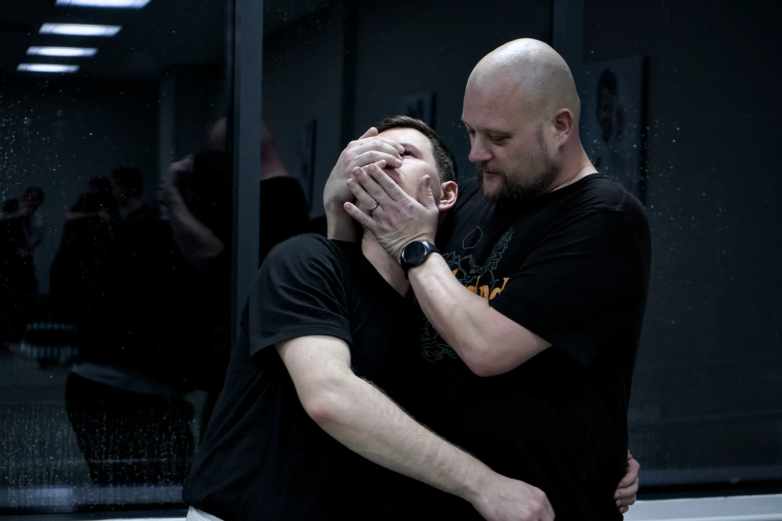 An instructor showing an adult student a close-range self-defence escape